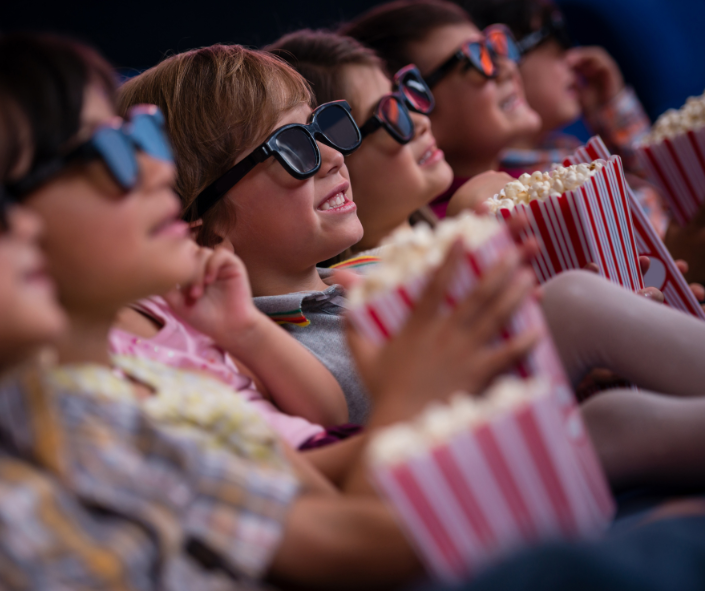 kids eating popcorn in cinema