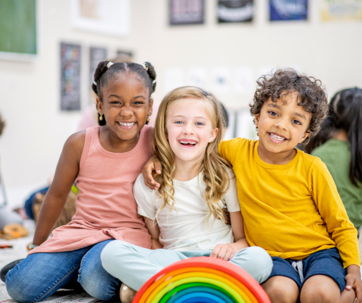 Happy Children, 3 children smiling, and hugging each other 